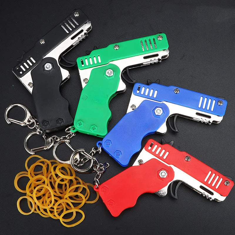 1pcs Mini Metal Gun Folding Rubber Band Toy Outdoor Sports Keychain Toy 6 Bursts Rubber Pistol Kids Gifts Party Favor Gun Toys